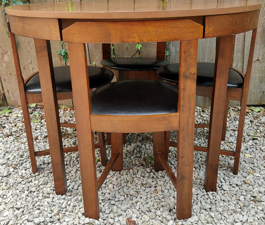 Modern 'Roundette' table with 4 tuck under chairs